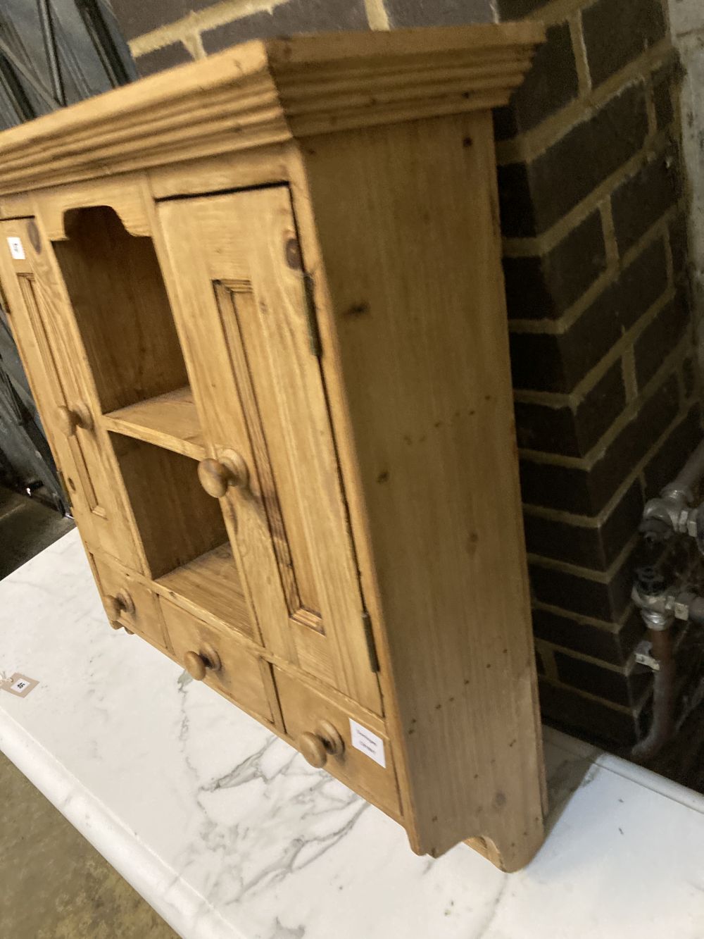 A small pine cabinet, width 69cm depth 23cm height 77cm